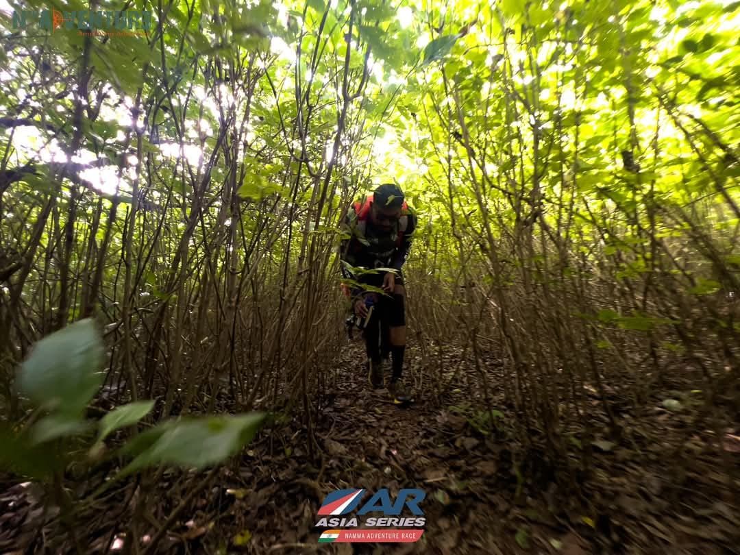 Manoj pushing through dense forest on a race leg